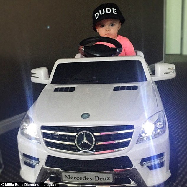 Baller: The toddler from Sydney's northern beaches is seen here 'looking gangsta in her new ride' a Mercedes Benz toy car