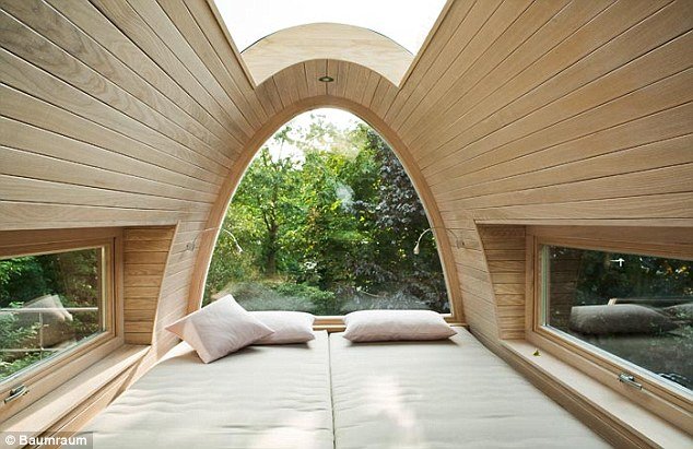 Cosy: The inside of the Münster tree house has a sleeping area and curved windows 